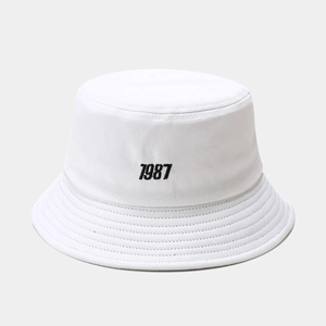 Detail of white cotton bucket hat with black 1987 print and stitched brim texture