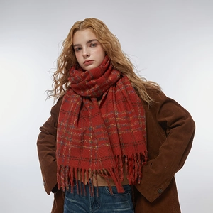 Classic red plaid scarf with tassel trim and thick warm fabric shown on a model