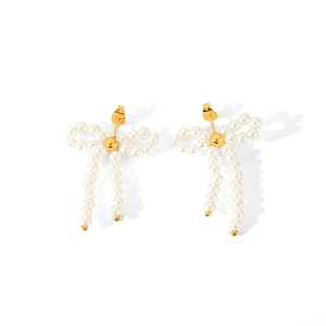 Detailed view of elegant 18K gold bow-shaped earrings with white pearl pendants