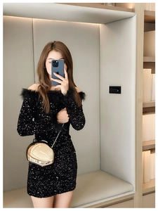 Close-up of a fashion model wearing a sequined dress with a gold mirror crossbody bag
