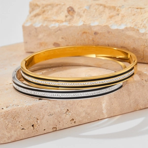 Minimalist gold and silver bracelets with black enamel and sparkling rhinestones