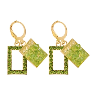 Elegant gold leaf earrings with green artificial stone and crystal inlay on white background