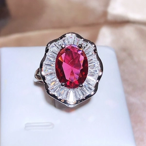 Elegant silver ring featuring a large oval red stone surrounded by crystal accents