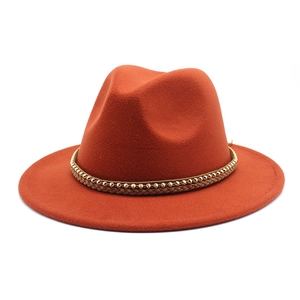 Detailed view of brick red wool fedora with a braided cord and gold beaded chain band