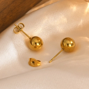 Polished gold round ball stud earrings with butterfly back on satin fabric