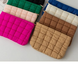 Flat lay of colorful quilted puffer pouches showing eight vibrant colors and textures