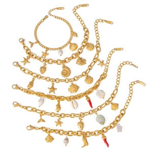 Gold stainless steel ocean charm bracelets with pearls and sea life on white background