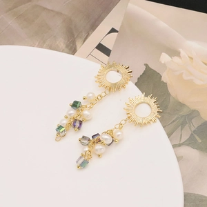 Detail of 18k gold plated sun drop earrings with freshwater pearls and colorful beads