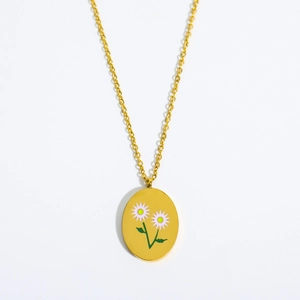 Vintage gold oval pendant necklace featuring delicate white floral enamel on cross chain