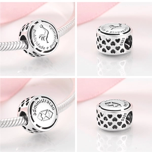 Detailed macro view of S925 sterling silver hollow charm with Portuguese text and heart pattern