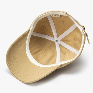 Internal view of khaki cotton baseball cap showing lining, sweatband and material label