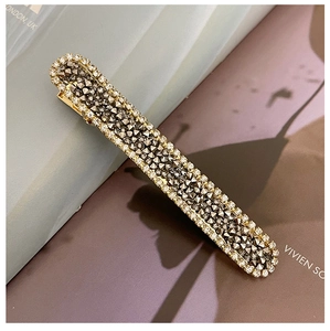 Detailed close-up of a sparkling rhinestone barrette hair clip with grey and clear crystals