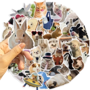 Close-up of waterproof pet stickers showing a hand holding a cute rabbit decal for scale