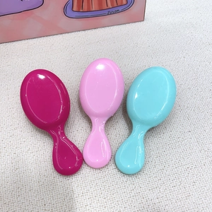 Three-piece set of portable mini hair brushes in bright pink and blue colors