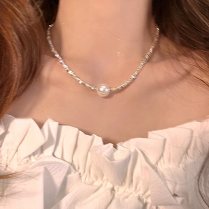 Minimalist silver necklace featuring a lustrous white pearl pendant on a delicate chain