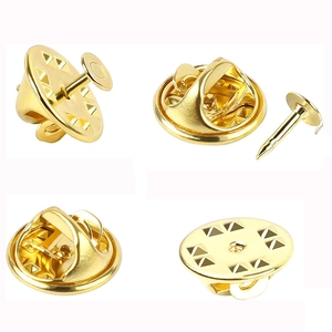 Macro view of gold-plated butterfly clutch pin backs and flat head tie tacks set