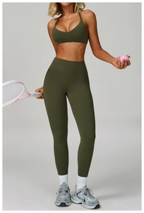 Detail of olive green halter neck yoga set with high waist compression leggings and tennis gear