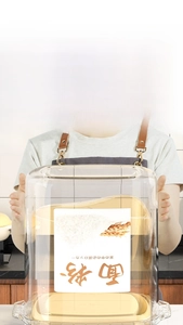 Close-up of a large airtight flour storage container with a sealed lid and clear body