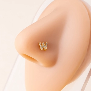 Macro shot of gold nose stud featuring letter W with micro-paved sparkling zircon stones