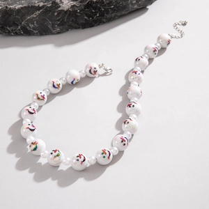Christmas snowman beaded necklace with faux pearls and silver clasp on gray background