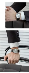 Detail of thin rectangular silver watch with black leather strap on a male wrist