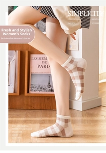 Detail of vintage brown plaid ankle socks with elastic ribbed cuffs on a model