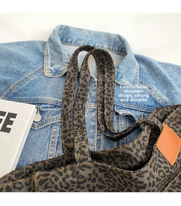 Close-up of leopard print canvas tote bag featuring durable straps and fabric texture