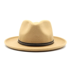 Detail of khaki wool fedora hat with black leather band and gold metal studs
