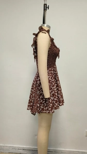 Detail of vintage brown floral mini dress with white polka dot ruffles and elastic waist