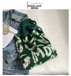 Detailed top view of green and white knitted tote bag with abstract jacquard pattern