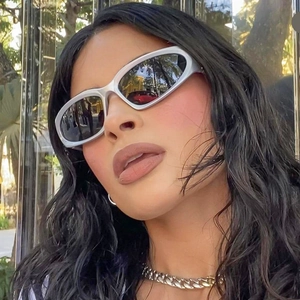 Close-up of silver steampunk cycling sunglasses with Y2K style on a model outdoors