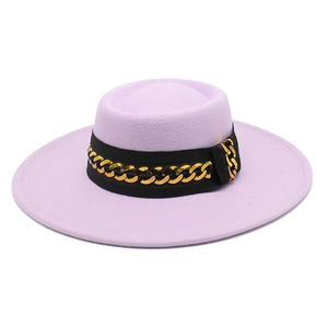 Detail of light purple wool fedora hat with black ribbon and gold chain embellishment