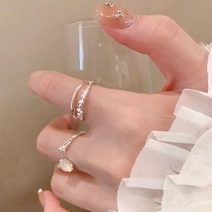 Detail of silver oval resin open ring with minimalist double-layer twisted band design