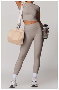 Detail of taupe athletic yoga set with cropped short sleeve top and high-waist leggings