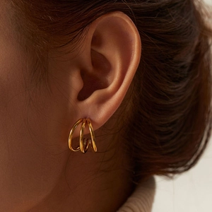 Three-layer interwoven 18K gold-plated stainless steel earrings on female model