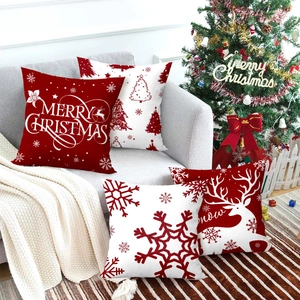 Christmas pillow covers set of 4 with reindeer and snowflake prints on sofa