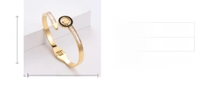 Dettaglio del bracciale a quadrifoglio dorato con dimensioni e strass scintillanti