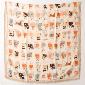 Close-up of beige silk cotton scarf featuring cute cartoon cat patterns and soft texture