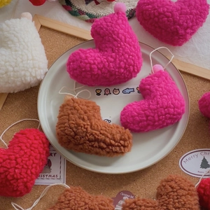 Detail of plush lamb wool heart ornaments in assorted colors for festive DIY decoration