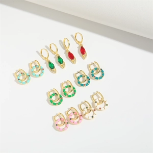 Colorful gemstone and enamel hoop earrings set in gold finish on a white background