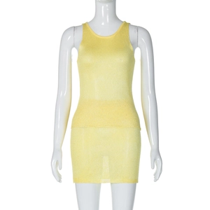 Detailed texture of yellow knit two-piece set featuring sleeveless top and mini skirt