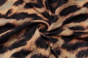 Macro shot of breathable leopard print mesh fabric with soft textures and pleated details