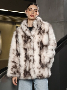 Chic winter faux fur coat with black and white textured plush and large lapel collar