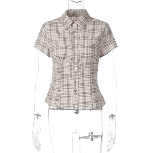 Detail view of the brown and beige plaid pattern on short sleeve button-up shirt