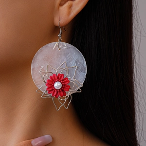 Vintage round shell drop earrings with red flower and pearl detailing on model