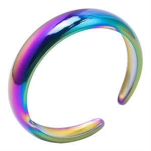 Close-up of rainbow iridescent adjustable open ring with a polished metallic finish