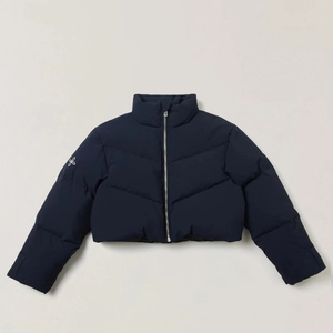 Detail of short navy down jacket showing high collar and silver zipper with white sleeve logo