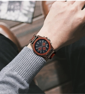 Macro shot of men's multifunctional sandalwood chronograph watch on wrist with wood dials