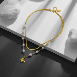 Double-layered gold blade chain necklace with irregular pearls and matte butterfly pendant