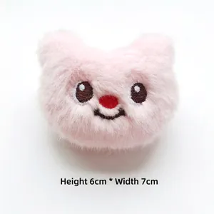 Close-up of pink plush bear head accessory with 6cm height and 7cm width dimensions